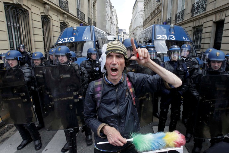 Image: An activist shouts slogan in front of French Gendarmes during a demonstration against the French labour law proposal in Paris