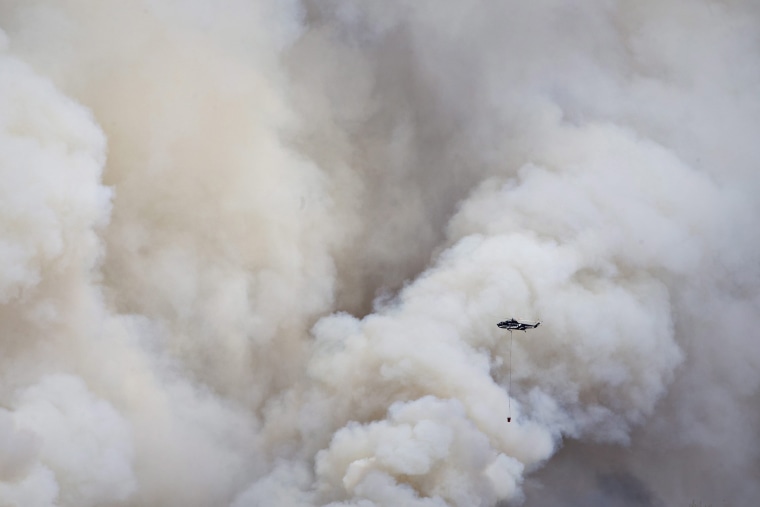 Image: A helicopter battles a wildfire in Fort McMurray, Alberta, Canada