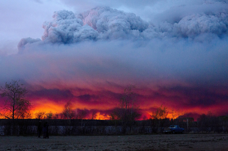 Image: A wildfire moves towards the town of Anzac from Fort McMurray, Alberta