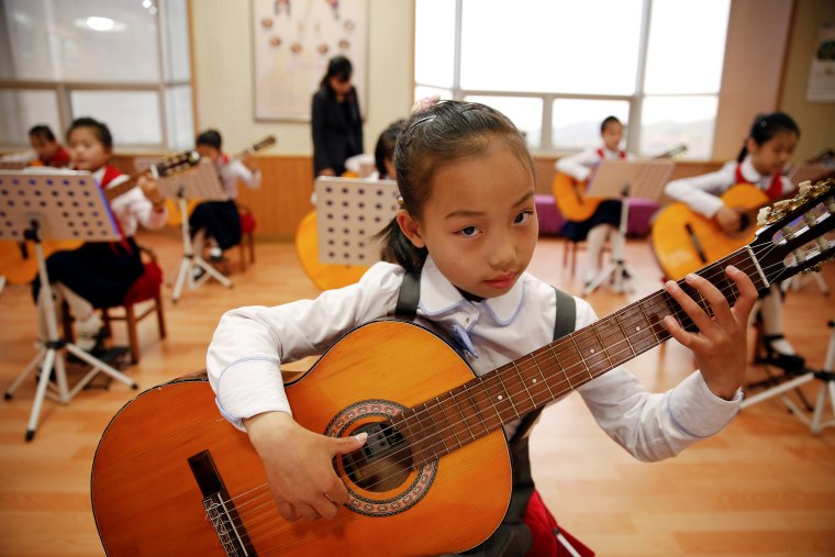 Image: Girls play guitars at the Mangyongdae Children's Palace in central Pyongyang