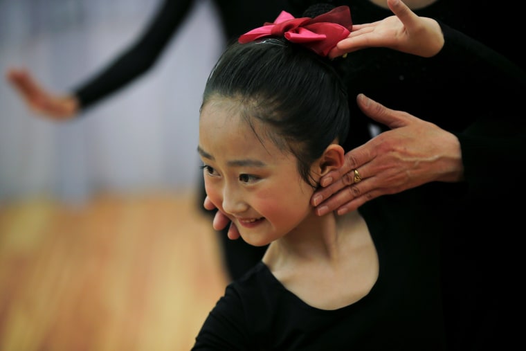 Image: A teacher gives instructions to a student practicing dance at the Mangyongdae Children's Palace in Pyongyang