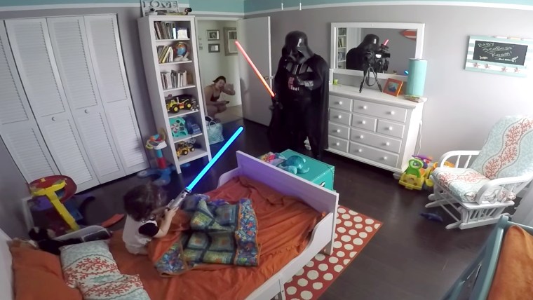 Father wakes his son up from nap dressed as Darth Vader
