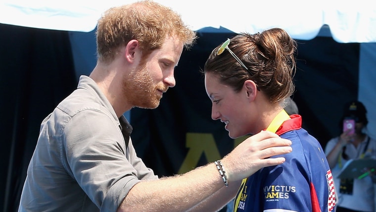 Prince Harry presents  USA Invictus Team Member Elizabeth Marks with a Gold Medal