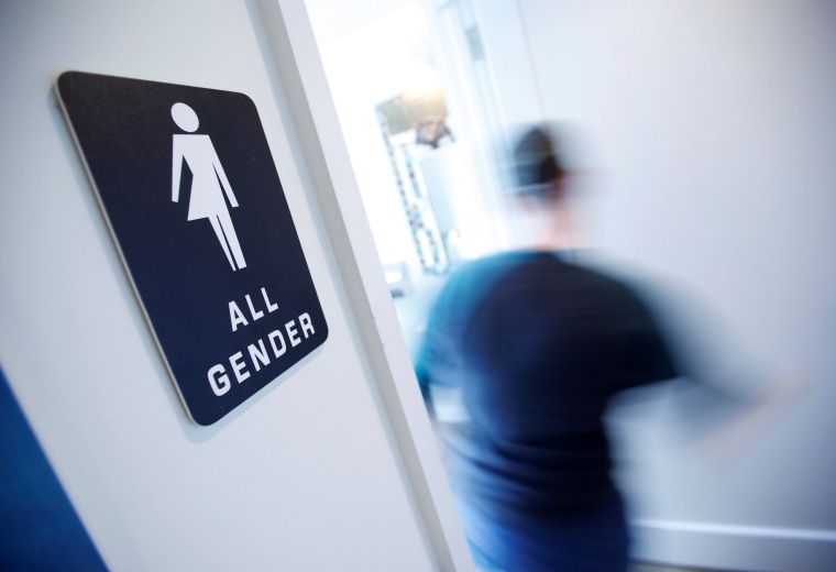 Image: A bathroom sign welcomes both genders at the Cacao Cinnamon coffee shop in Durham, North Carolina