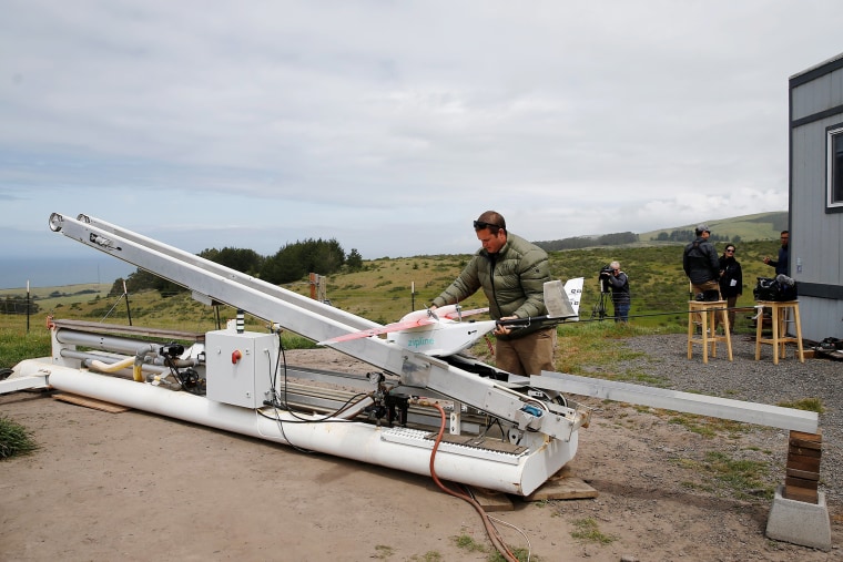 Image: Brett Alo places a Zipline aerial delivery drone on its launcher during a flight demonstration at an undisclosed location in the San Francisco Bay Area, California