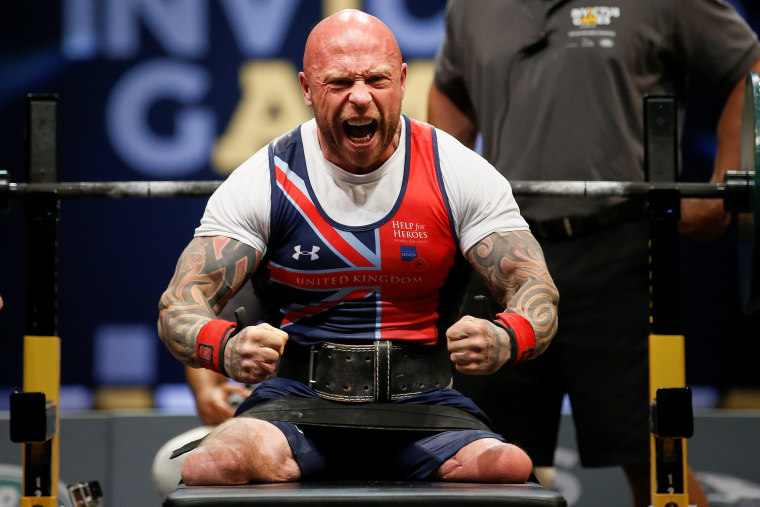 Image: Wounded warrior Michael Yule celebrates after winning the Lightweight Power Lifting gold during the Invictus Games in Orlando, Florida