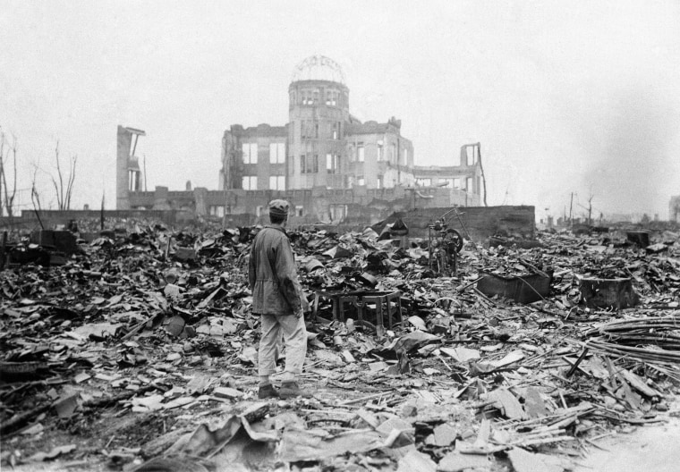 In this Sept. 8, 1945 file photo, an allied correspondent stands in the rubble in front of the shell of a building that once was a movie theater in Hiroshima, Japan, a month after the first atomic bomb ever used in warfare was dropped by the U.S. on Aug. 6, 1945.