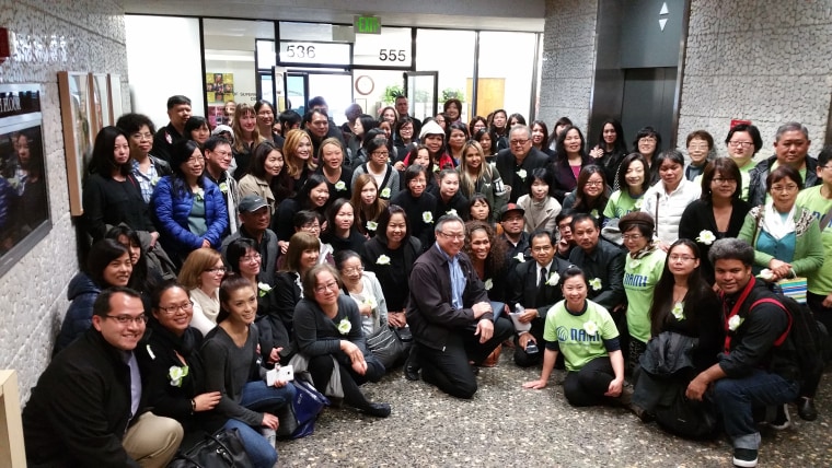 Supporters of staff at ACMHS take a group picture while attending an Alameda County health meeting to go over the findings of a financial audit of the organization.