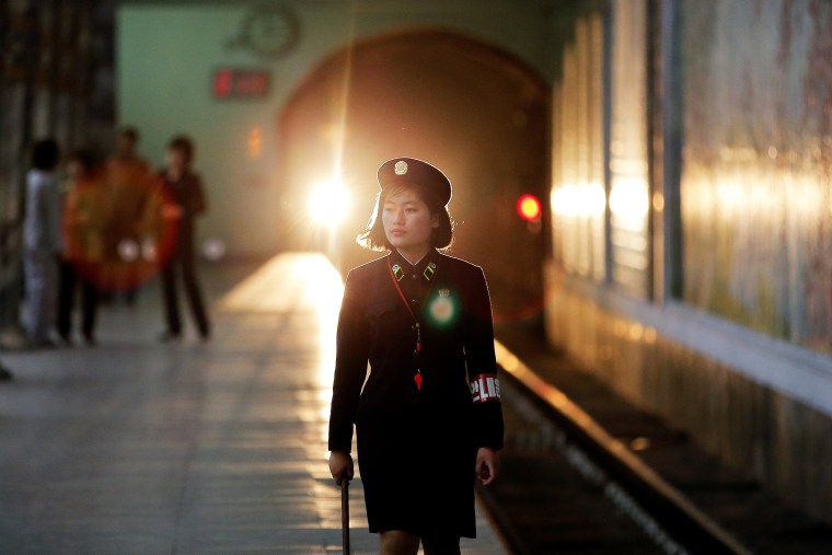 Image: A subway worker walks away after a train departed the station in central Pyongyang