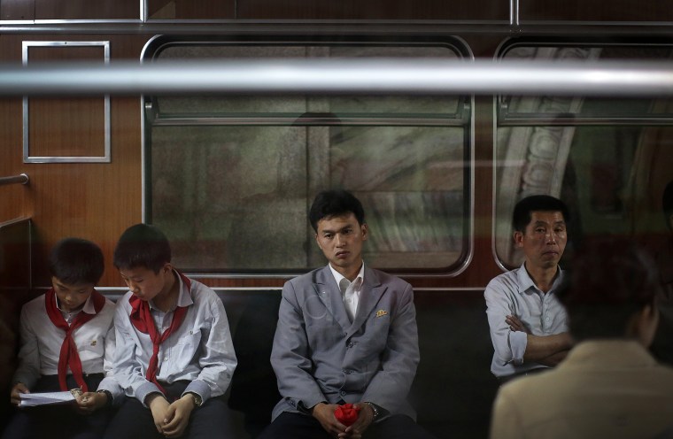 Image: North Korean commuters ride in a subway car