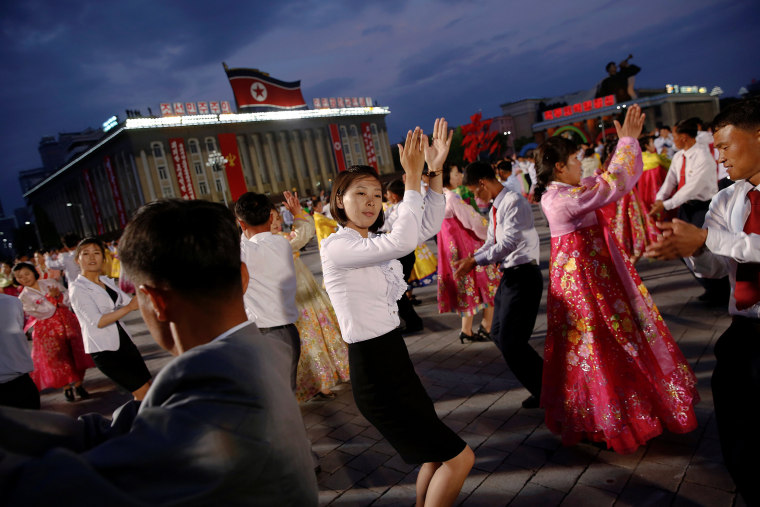 Image: People participate in a mass dance in the capital's main ceremonial square, a day after the ruling Workers' Party of Korea party wrapped up its first congress in 36 years, in Pyongyang