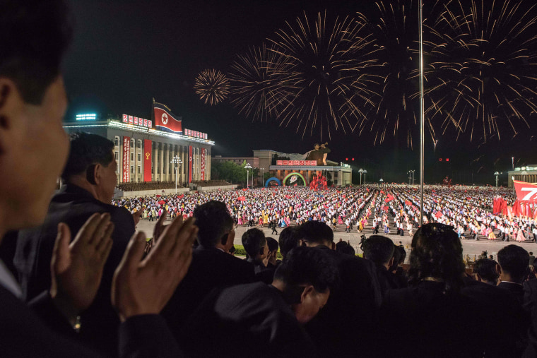 Image: Spectators applaud during a parade on Kim Il-Sung square