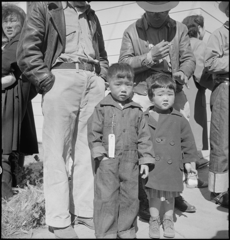 Original WRA caption: Turlock, California. These children have just arrived at Turlock Assembly center. Evacuees of Japanese ancestry will be transferred later to a War Relocation Authority center for the duration.