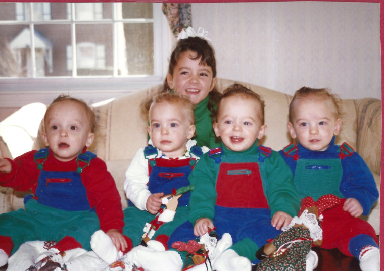 The Lomaka quads as babies with their older sister Lauren, who was adopted when their parents were told they could not have biological children.