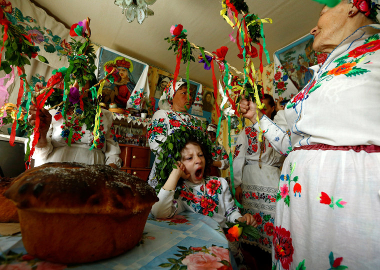 Image: Villagers take part in a ritual celebrating the pagan god Yurya and pray for plentiful future harvests in the village of Pogost