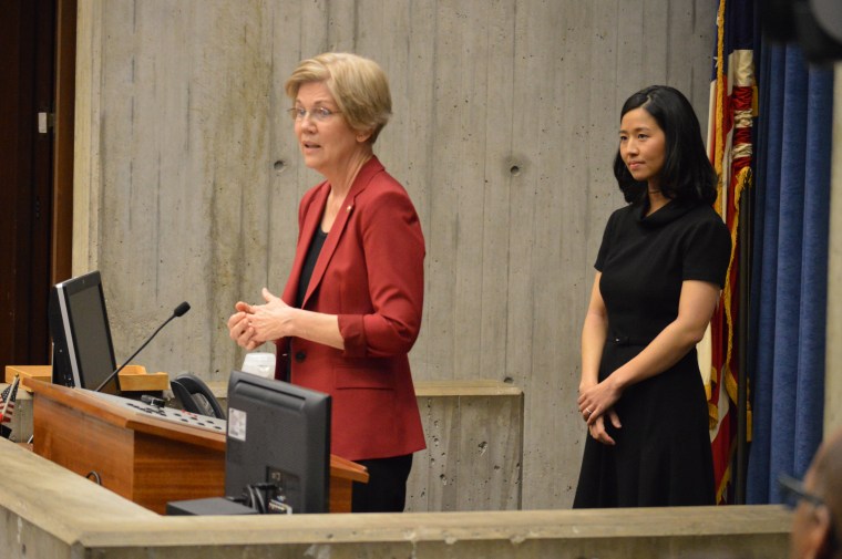 Sen. Elizabeth Warren of Massachusetts, left, speaks about Michelle Wu, her former law school student, after Wu was elected president of the Boston City Council, in the council chambers on January 4, 2016.