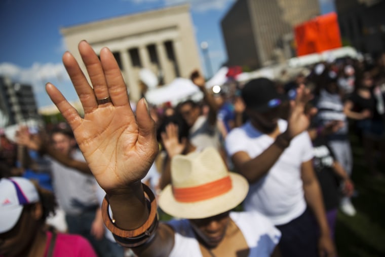 People pray during a rally at City Hall in Baltimore, where hundreds of jubilant people prayed and chanted for justice days after the city's top prosecutor charged six officers involved in Freddie Gray's arrest on May 3, 2015.