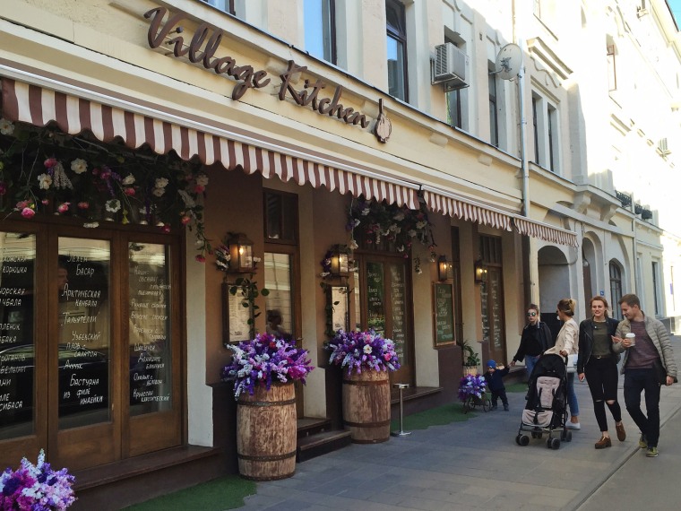 Pedestrians pass a restaurant in central Moscow.