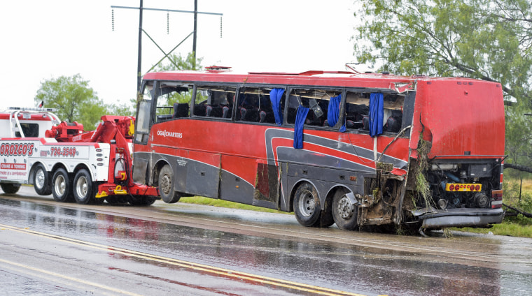 A damaged OGA Charters bus is hauled away after a fatal rollover on Saturday, May 14, 2016, south of the Dimmit-Webb County line on U.S. 83 North in Texas.