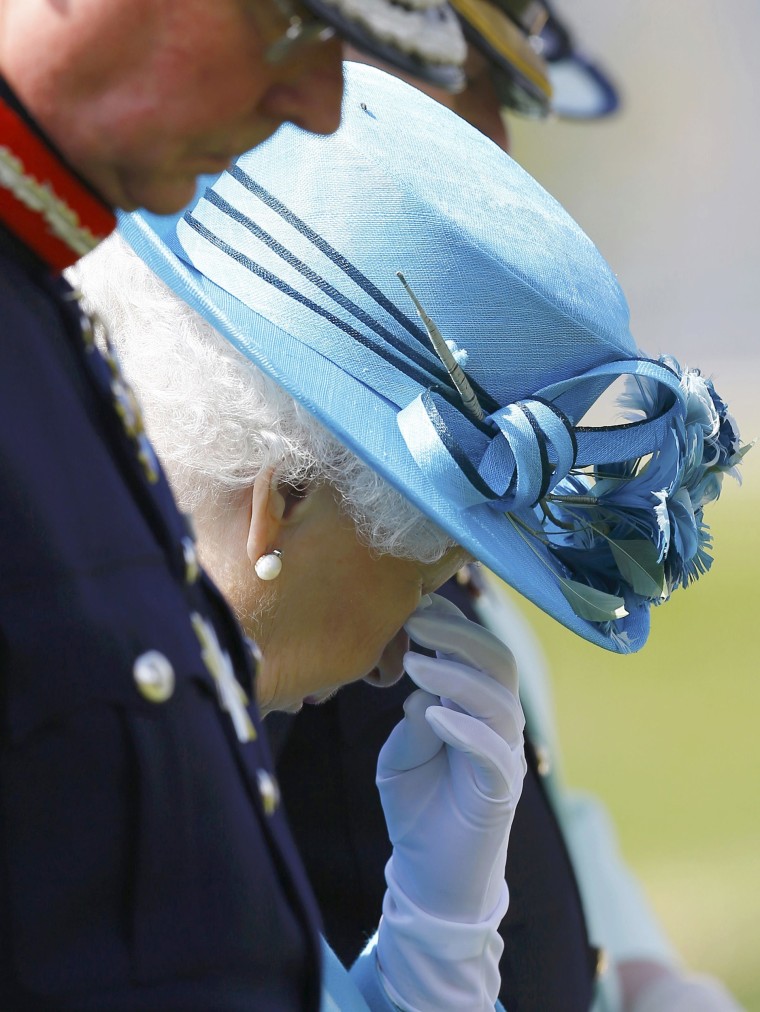 Britain's Queen Elizabeth wiping away a tear while attending dedication of The Lancaster's Regimental Memorial.