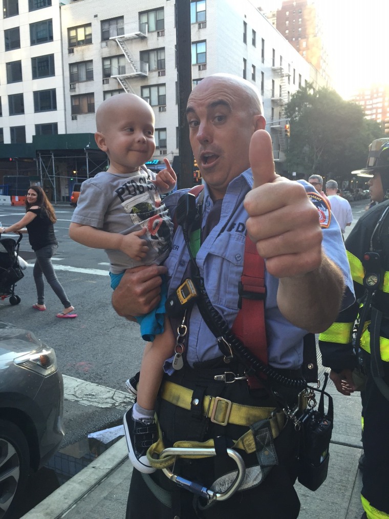 Fireman Captain Grismer with toddler Trucker Dukes