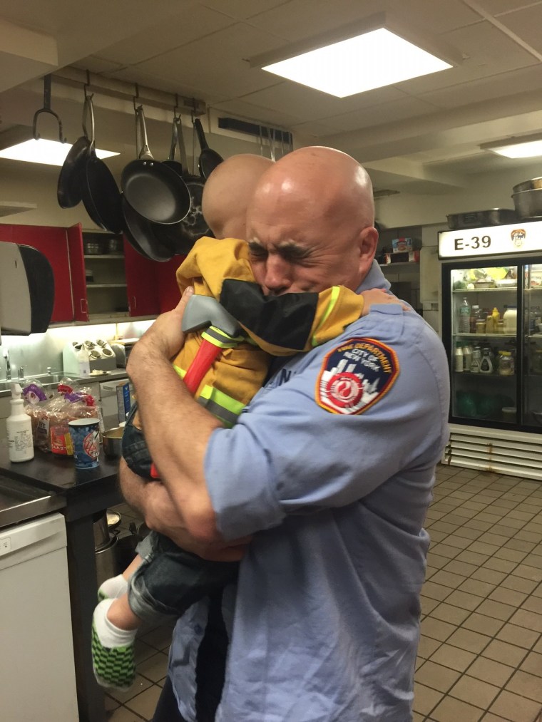 Boy and firefighter hug