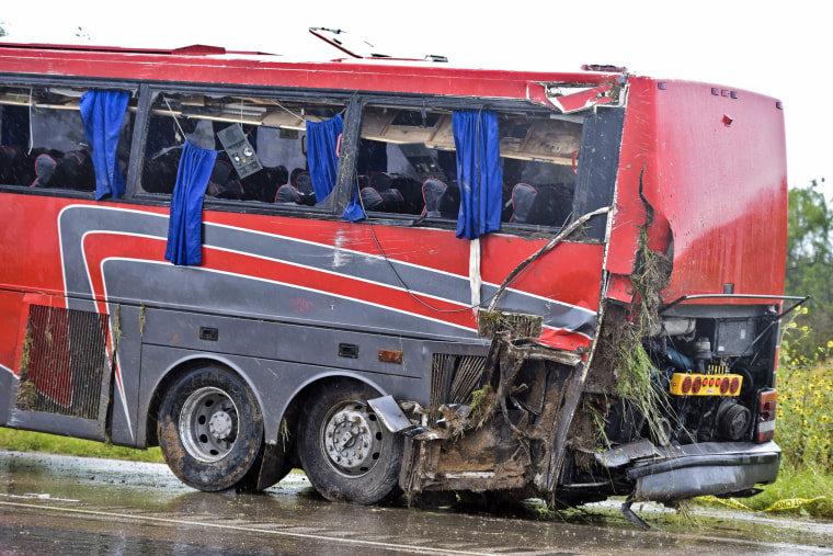Image: A damaged OGA Charters bus is hauled away after a fatal rollover