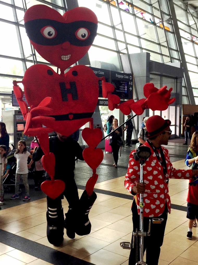 Fern Street Circus performers entertain travelers at the San Diego International Airport.