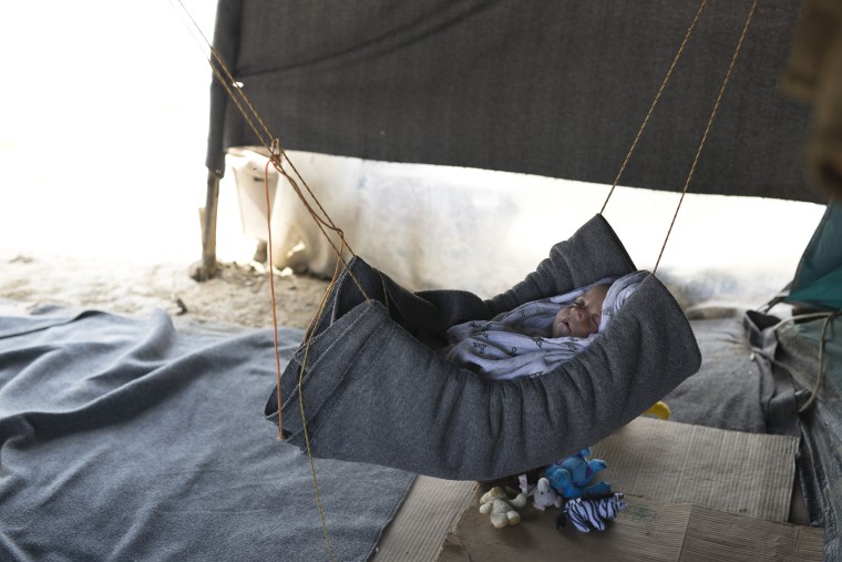 Image: A five-month-old Syrian baby sleeps inside a tent at a makeshift refugee camp in Idomeni