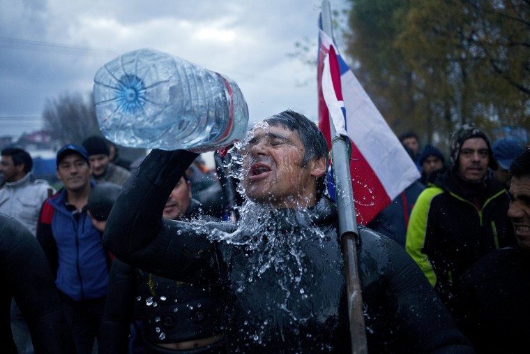 A diver throws water on his face during a protest march by shellfish divers in Chiloe Island, Chile.