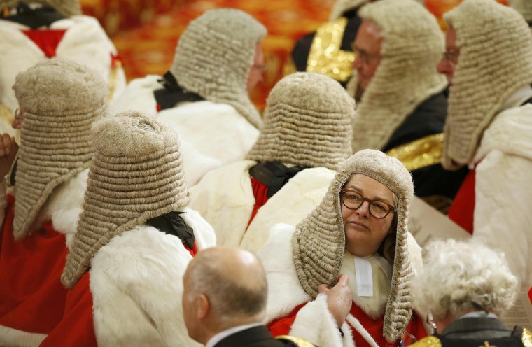 Members of the Law Lords, Britain's senior judiciary, take their seats as they wait for Britain's Queen Elizabeth to read the Queen's Speech during the State Opening of Parliament in the House of Lords in London
