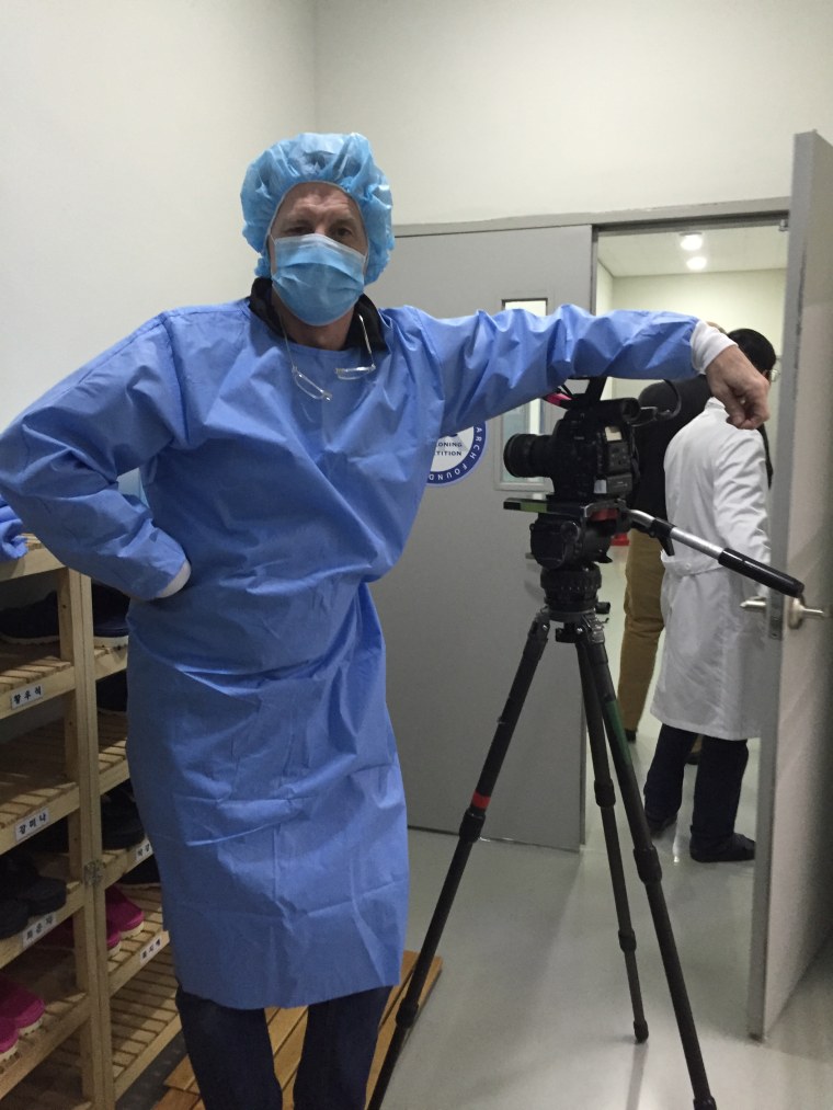 One of the cameramen for 'On Assignment' suited up to shoot inside the "clean lab" at the SOOAM Biotech Research Foundation, the only place in the world that offers commercial cloning of dogs.