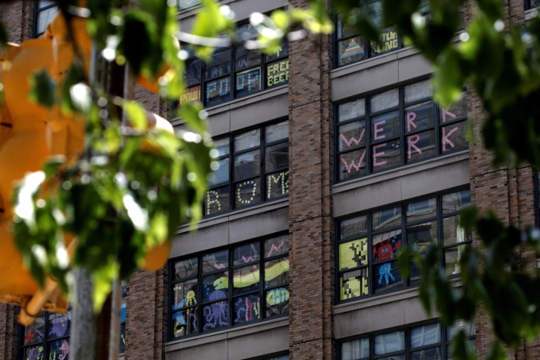 Image: Images created with Post-it notes are seen in windows of 200 Hudson street in lower Manhattan, New York