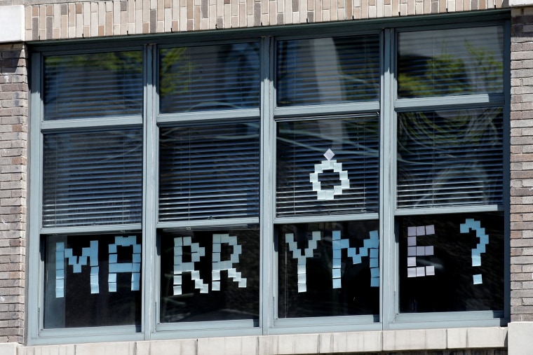 Image: A message created with Post-it notes are seen in windows of 200 Hudson street in lower Manhattan, New York during \"Post-it note art war\"