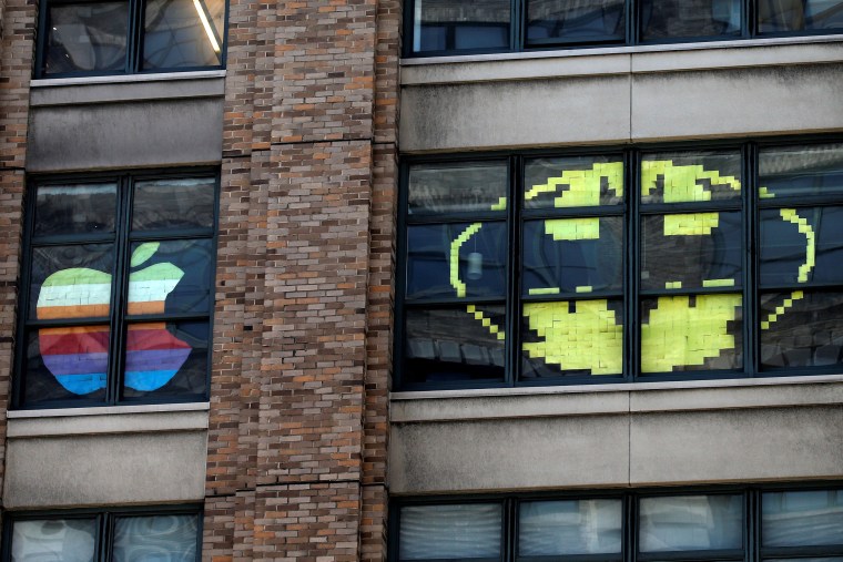 Image: Images created with Post-it notes are seen in the windows of offices at 75 Varick Street in lower Manhattan, New York during \"Post-it note art war\"