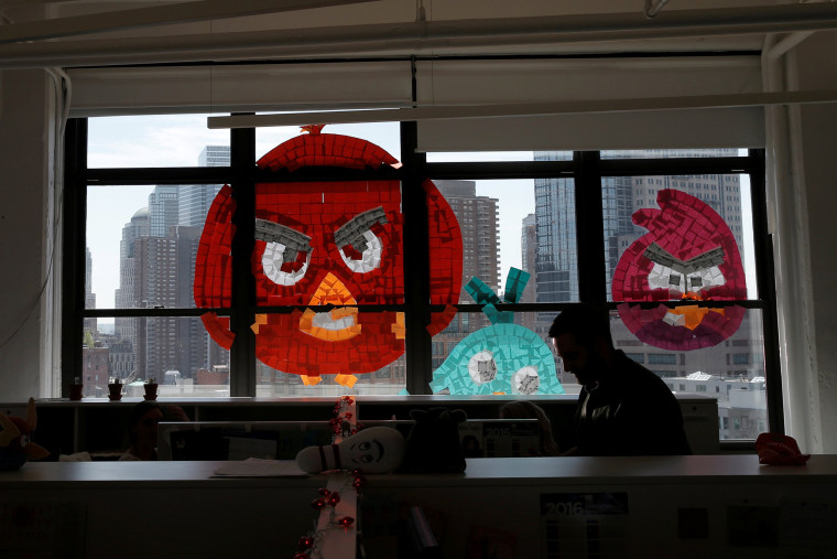 Image: Images of Angry Birds created with Post-it notes are seen on a window created with Post-it notes at the Horizon Media offices at 75 Varick Street in lower Manhattan, New York during \"Post-it note art war\"