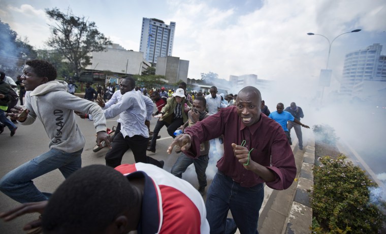 Image: Protesters flee from clouds of tear gas fired by riot police in Nairobi