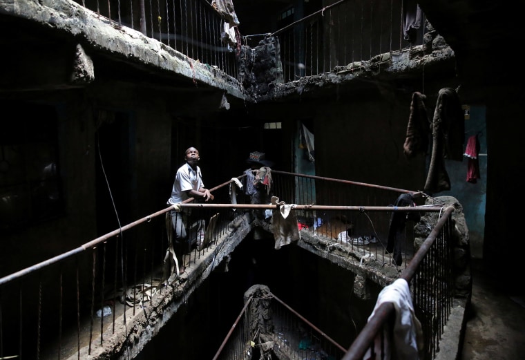Image: A man stands in a building earmarked for demolition in Nairobi