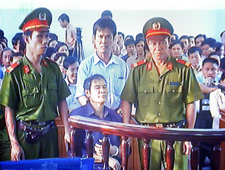 Catholic priest Nguyen Van Ly, center, is seen at a court room in Vietnam's central province of Thua Thien Hue in this image taken through close-circuit TV, on March, 30, 2007.