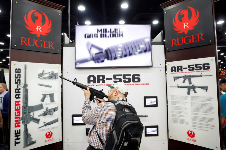 Image: Attendees visit the trade booths during the National Rifle Association's annual meeting in Louisville, Kentucky