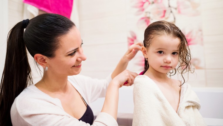 Mother brushing child hair