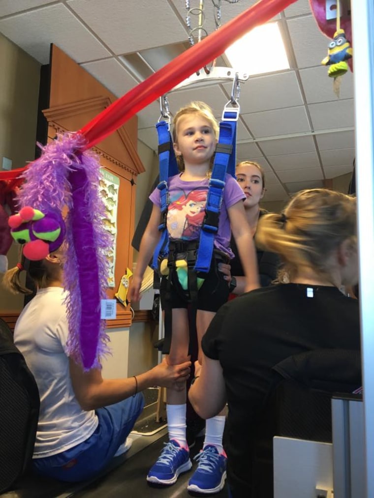 Eden Hoelscher practices walking on the treadmill.