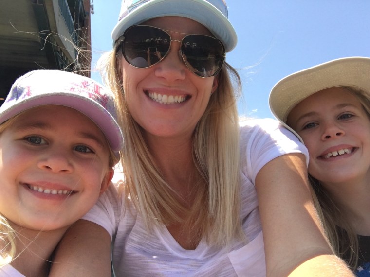 Eden attends a baseball game with mother Kylee and sister Isabella.