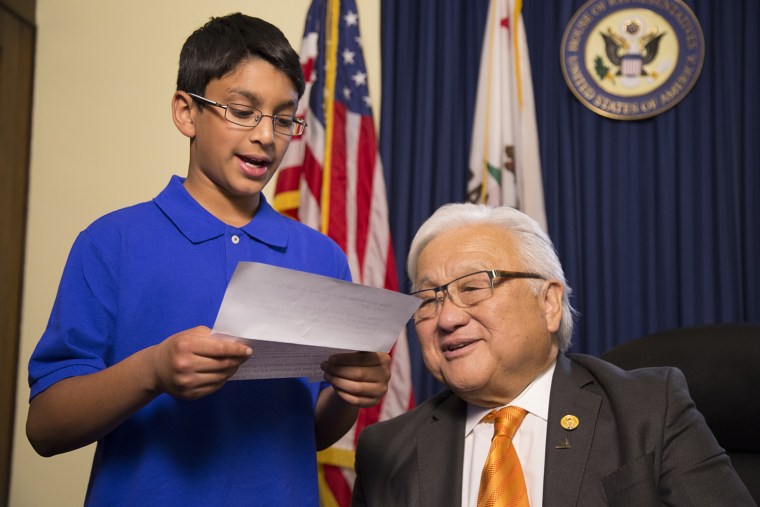 A student reads a letter written by a Japanese American incarcerated during World War II to Rep. Mike Honda.