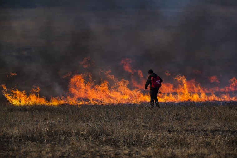 Image: A firefighter battles a blaze in Russia's Zabaikalsky region