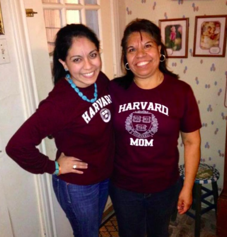 Norma Torres Mendoza and her mother, Carmen Torres, proudly pose in their Harvard crimson t-shirts.