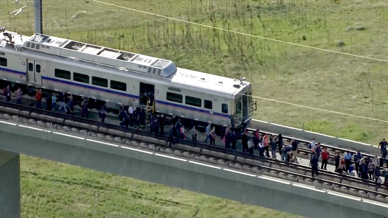 Eighty passengers were stuck 50 feet above the ground after the rail line to Denver International Airport got stuck on an overpass above Pena Boulevard Tuesday afternoon.