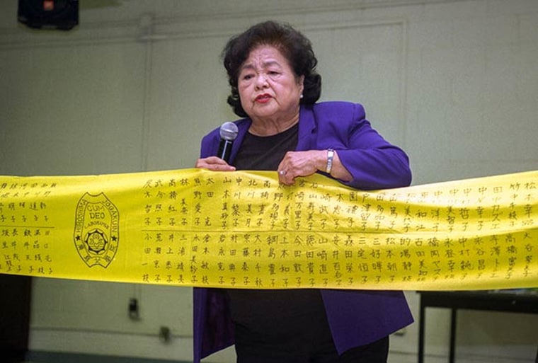 Setsuko Thurlow speaking to high school students in 2013. On the yellow banner are the names of 331 girls from Thurlow's school who died on Aug. 6, 1945.