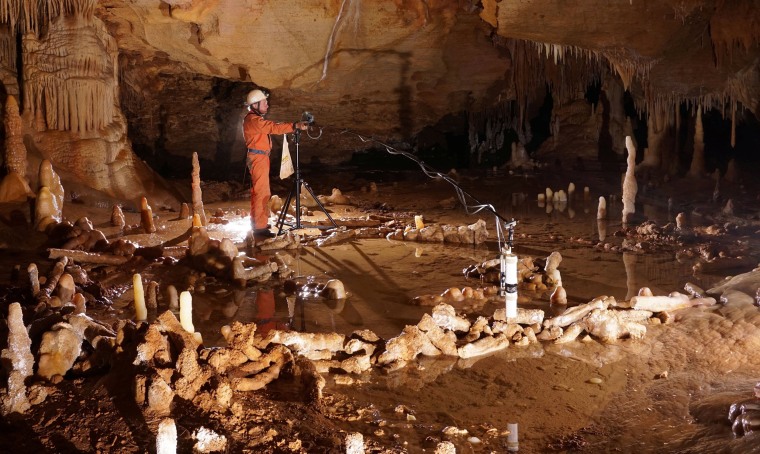 Image: A scientist takes measurements for the archaeo-magnetic survey in the Bruniquel Cave in southwestern France in this undated handout photo