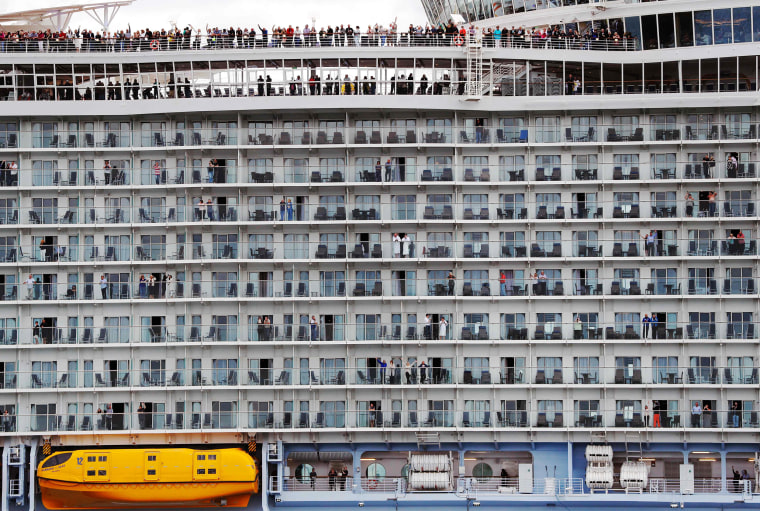 Image: Passengers wave from the decks as the Harmony of the Seas cruise ship sets sail